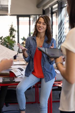 Young Professionals Engaging in Collaborative Meeting in Modern Office Space