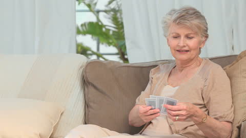 Senior Woman Enjoying Solitaire at Home