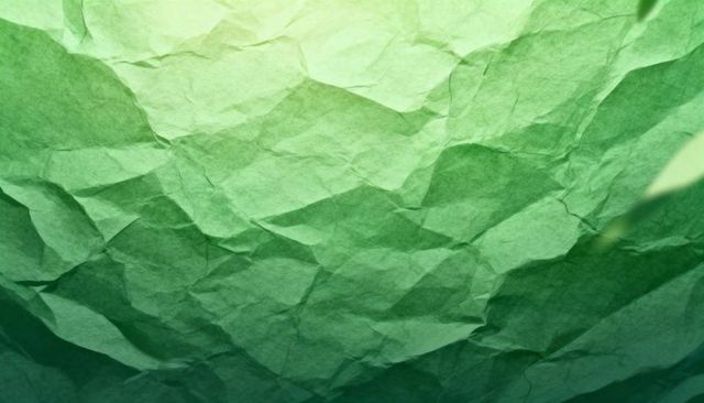 Crumpled green paper texture with gradient wrinkles and abstract geometric fold for design