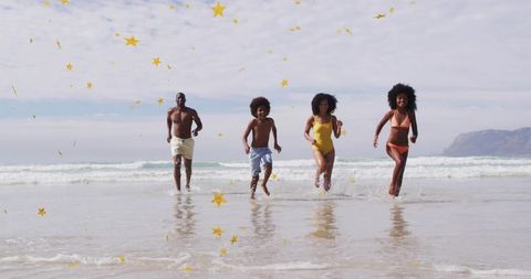 Family sprinting through surf with golden star confetti on sunlit beach celebrating summer