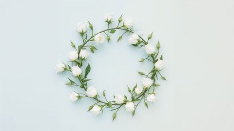 Circular Wreath of White Rosebuds on Pastel Background