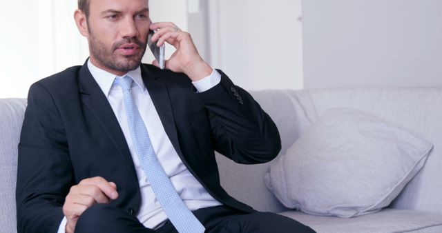 Business Professional Talking on Phone in Modern Office Setting - Download Free Stock Images Pikwizard.com