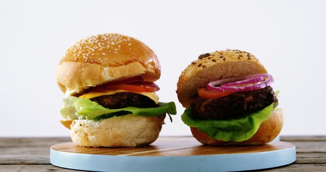 Shows cheeseburger and veggie burger on a wooden board, highlighting diverse meal options. Perfect for food blogs, advertisements promoting fast food restaurants, or healthy eating guides to contrast traditional and vegetarian options.