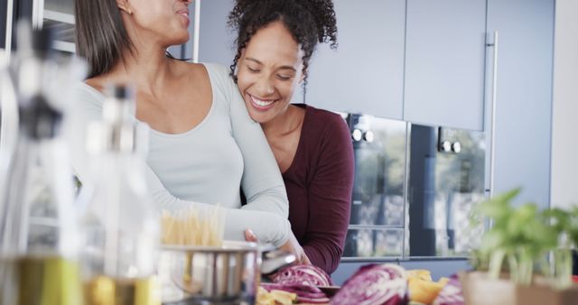 Happy family cooking together, mother and daughter sharing a hug - Download Free Stock Images Pikwizard.com