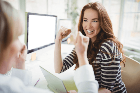 Cheerful Woman Celebrating Success with Colleague at Transparent Office Desk - Download Free Stock Videos Pikwizard.com
