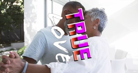 Older couple touching heads and dancing by glass doors with romantic true love text overlay