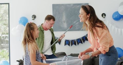 Family enjoying cleaning together after birthday celebration