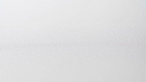 Minimal white textured canvas surface featuring fine woven fibers and subtle grain details