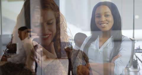 Smiling Businesswomen and Multitasking Global Communication