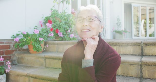 Smiling Elderly Woman Relaxing in Sunlit Garden - Download Free Stock Images Pikwizard.com