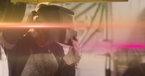 Female Technician Inspecting Welding Work in Repair Workshop