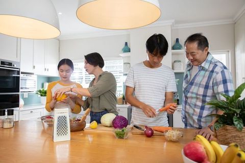 Family Preparing Colorful Meal Together in Modern Kitchen