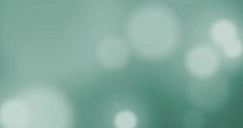 Glowing light spots on soft green gradient background