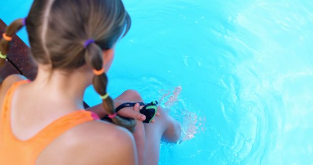 Girl Sitting by Pool's Edge Dipping Her Feet in Water - Download Free Stock Images Pikwizard.com