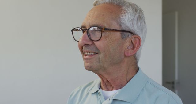 Image of happy caucasian senior man wearing glasses looking at camera. retirement and senior lifestyle concept.