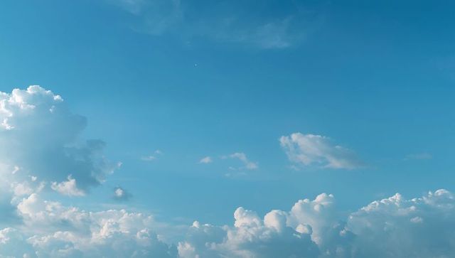 Vast Blue Sky and Fluffy Cumulus Clouds in Tranquil Atmosphere