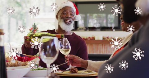 Celebrating Christmas with Wine: African American Senior Couple at Festive Dinner
