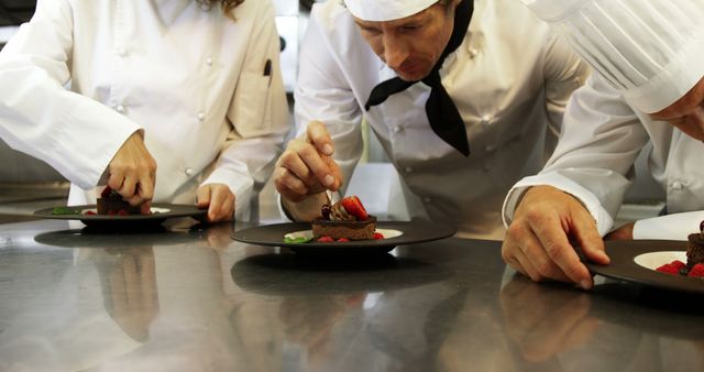 Chefs Carefully Plating Dessert Dishes in Restaurant Kitchen - Download Free Stock Images Pikwizard.com