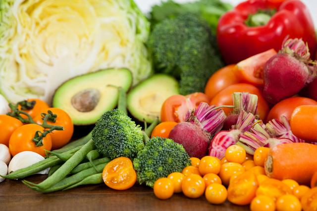 Close-up of a variety of fresh vegetables and fruits on a table, showcasing vibrant colors and healthy options. Ideal for use in articles, blogs, and advertisements related to healthy eating, diet plans, organic produce, vegetarian and vegan lifestyles, and nutrition tips.