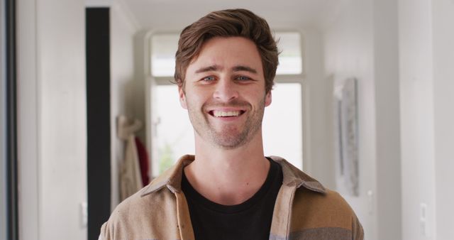 Image of happy caucasian man looking at camera. Lifestyle and spending time at home concept.