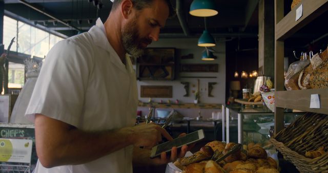 Bearded Baker in Shop Using Tablet for Inventory - Download Free Stock Images Pikwizard.com