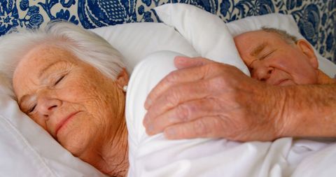 Elderly Couple Peacefully Sleeping Together in Bedroom
