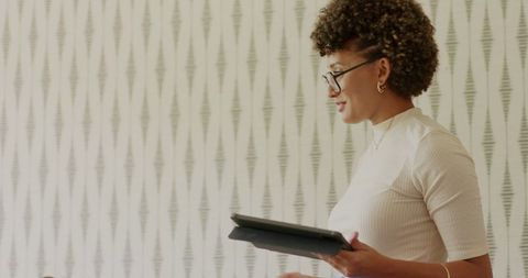 Professional woman listening holding tablet in living room