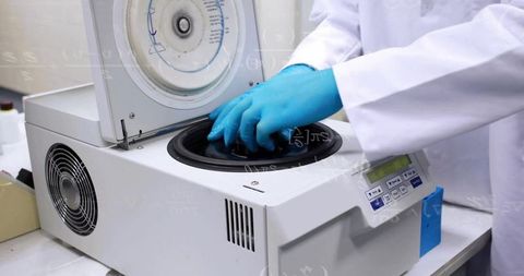 Technician Operating Benchtop Centrifuge in Modern Laboratory
