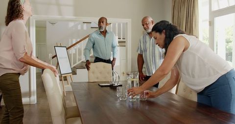 Diverse seniors preparing dining table for celebration