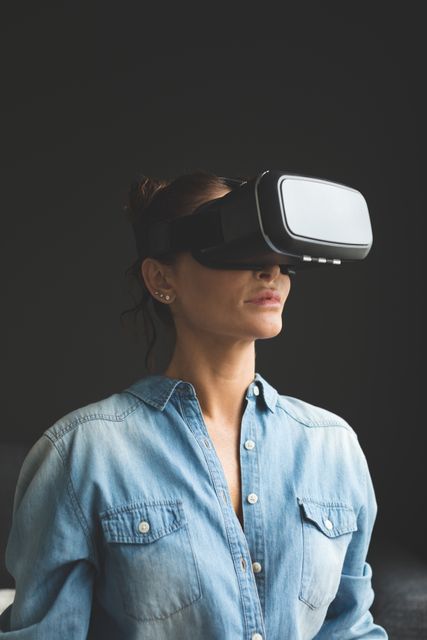 Beautiful woman using virtual reality headset in a comfortable home