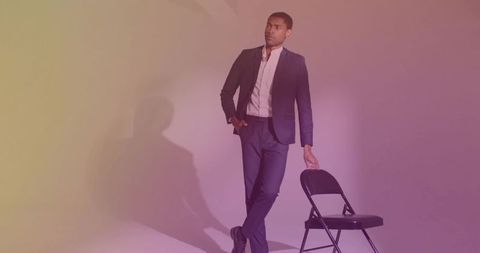 Casually elegant man in tailored suit leaning on chair