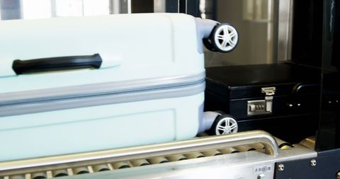 Luggage on baggage carousel at modern airport terminal