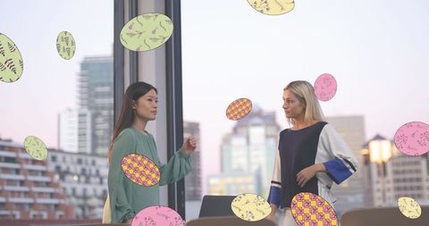 Women Collaborating in Urban Office with Overlayed Geometric Design