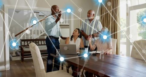 Multigenerational family discussing smart home network and financial planning at dining table