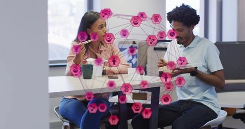 Office colleagues sharing lunch with hexagon network overlay illustrating digital collaboration