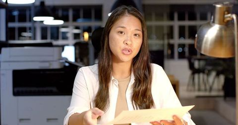 Biracial businesswoman discussing documents in office
