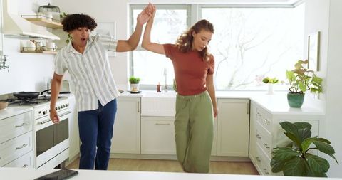 Joyful Couple Dancing in Modern Kitchen