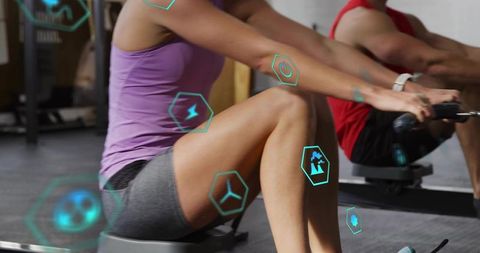 Indoor ergometer rowing with smartwatch and fitness HUD overlay