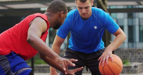 Two Diverse Basketball Players Intensely Competing