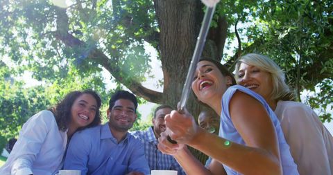 Diverse Group Smiling While Taking Selfie Outdoors