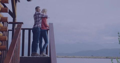 Couple Embracing While Overlooking Scenic Lakeside Mountain View