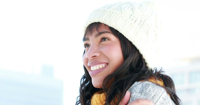 Cheerful Latina Girl Embracing Winter in Cozy Hat and Scarf - Download Free Stock Images Pikwizard.com