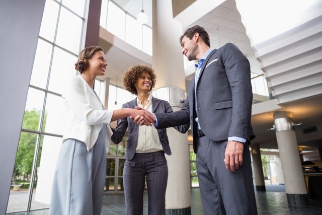 Business executives shaking hands with each other at conference centre