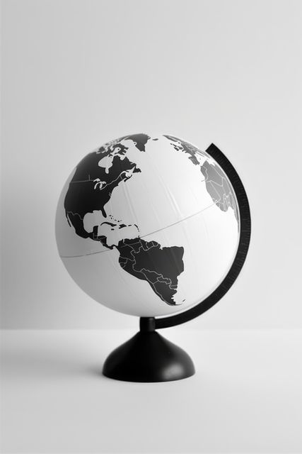A monochrome globe sits on a plain background, with copy space. Ideal for educational settings, it emphasizes geography and global awareness.
