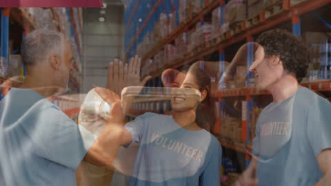 Volunteers Celebrating in Warehouse Interacted with Technology