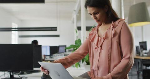 Focused Businesswoman Working Remotely in Modern Office Environment