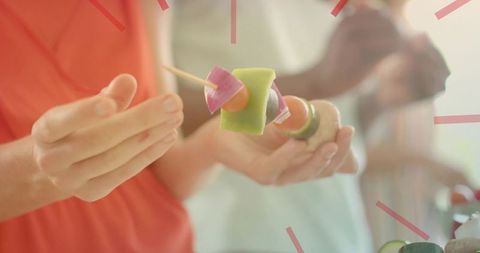 Threading colorful vegetable skewers for summer gathering