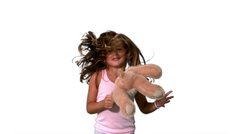 Joyful Girl Playing with Teddy Bear in Motion