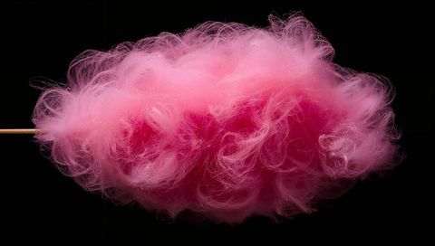 Pink Cotton Candy Cloud Floating on Wooden Stick Against Black Backdrop, Fluffy Texture