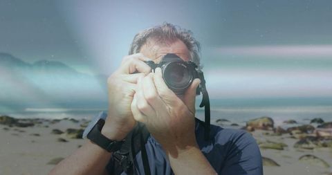 Photographer documenting serene beach with dslr camera